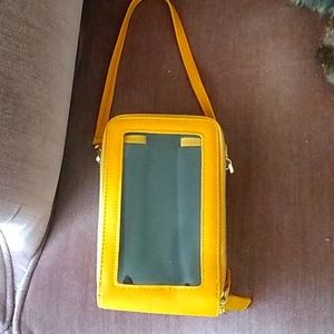 Cellphone purse with transparent window for phone activity.